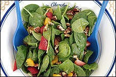 Baby spinach salad with strawberries, oranges and toasted pecans