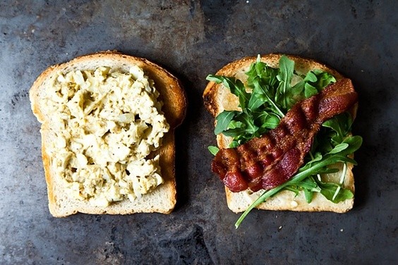 Bacon and egg salad sandwich with dukkah and peppery greens