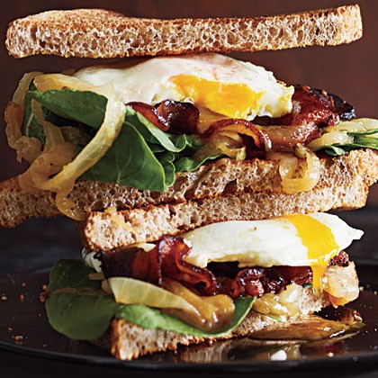 Bacon and egg sandwiches with caramelized onions and arugula