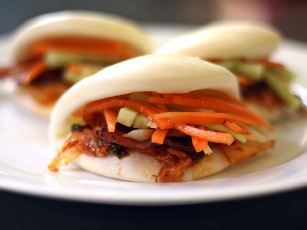 Bacon and kimchi steamed buns with carrot and cucumber slaw