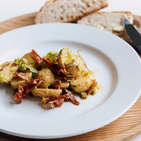 Bacon and potato salad with green celery leaf and cider vinegar