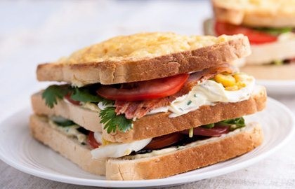 Bacon, egg, tomato and cheddar-garlic mayo club sandwich