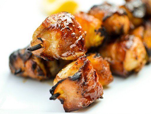 Bacon-wrapped chicken skewers with pineapple and teriyaki sauce