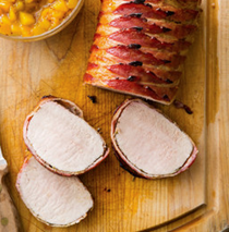 Bacon-wrapped pork roast with peach sauce