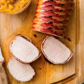 Bacon-wrapped pork roast with peach sauce