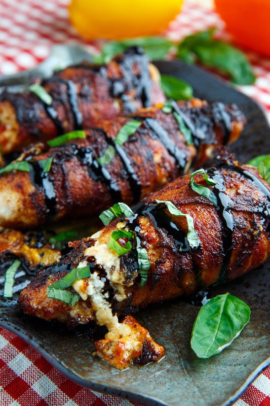 Bacon wrapped roasted red pepper and goat cheese stuffed chicken with balsamic drizzle and basil