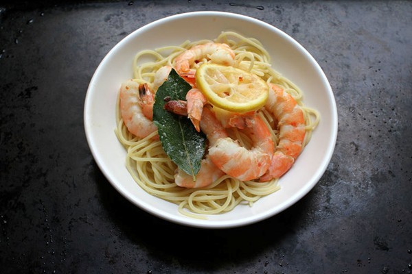 Baked and buttered shrimp over pasta