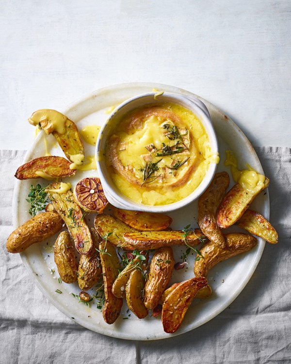 Baked Baronet cheese with herbs and garlic roast potatoes 