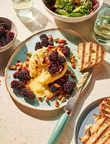 Baked brie with pickled blackberries and thyme roasted nuts