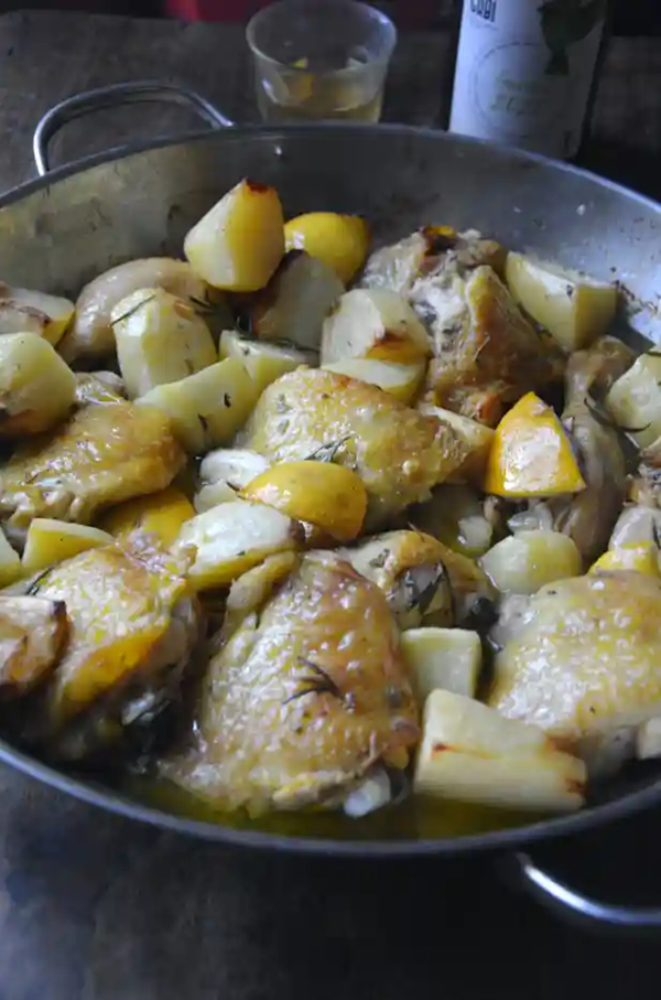 Baked chicken and potatoes with lemon and rosemary