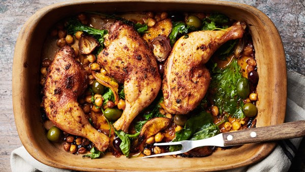 Baked chicken legs with chickpeas, olives, and greens