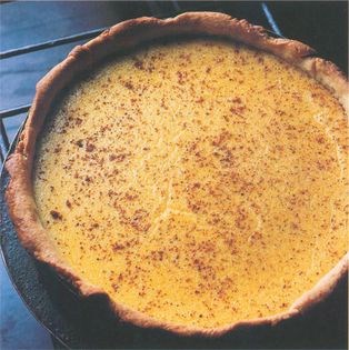 Baked egg custard, scented with rosewater, served with elderflower sorbet and crystallized strawberries