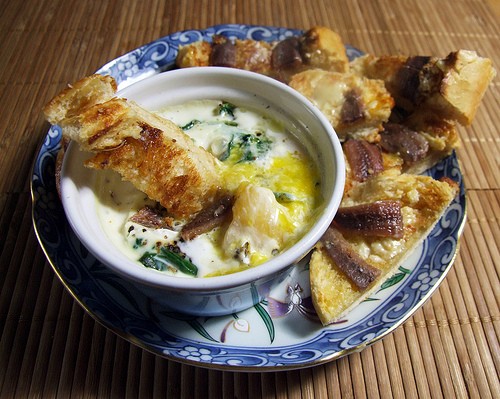 Baked egg with anchovy soldiers