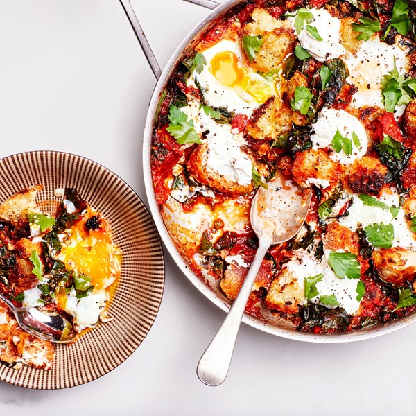 Baked eggs and greens in harissa tomato sauce 