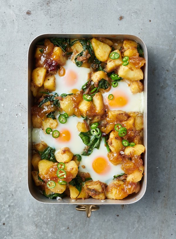 Baked eggs and potatoes with spinach