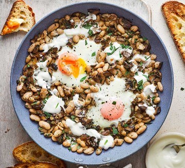 Baked eggs with beans, mushrooms, tarragon & crème fraîche