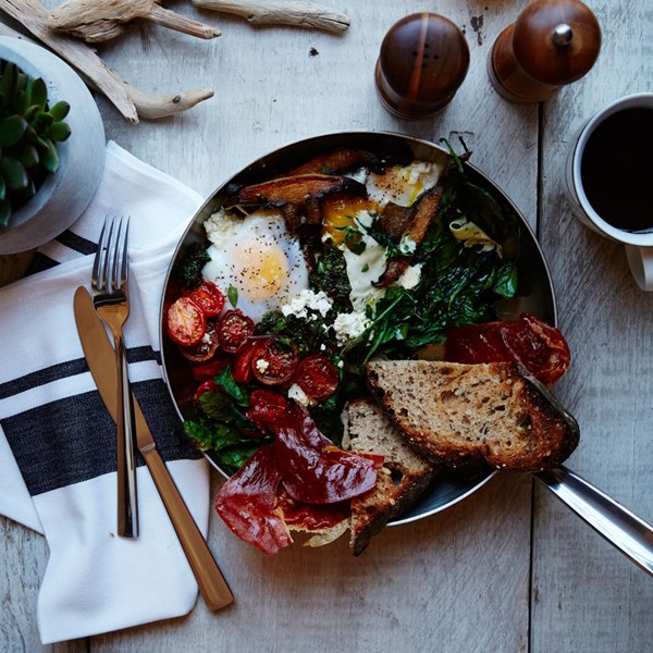 Baked eggs with chimichurri and prosciutto