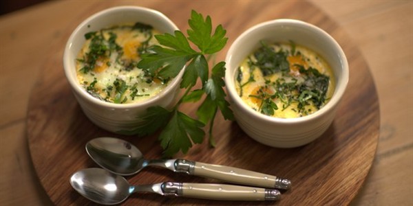 Baked eggs with garden greens and cream