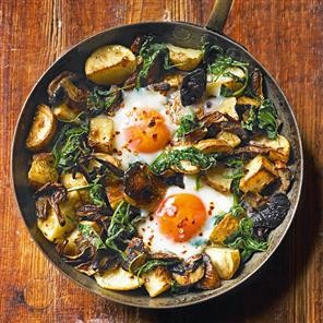 Baked eggs with mushrooms, potatoes, spinach and Gruyère