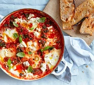 Baked eggs with spinach, tomatoes, ricotta & basil