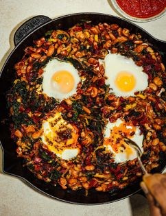 Baked eggs with tadka greens