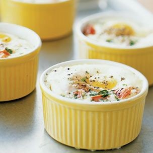 Baked eggs with tomatoes, herbs, and cream