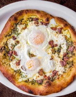 Baked farm eggs, ricotta, and pancetta [pizza] (Pizza uovo)