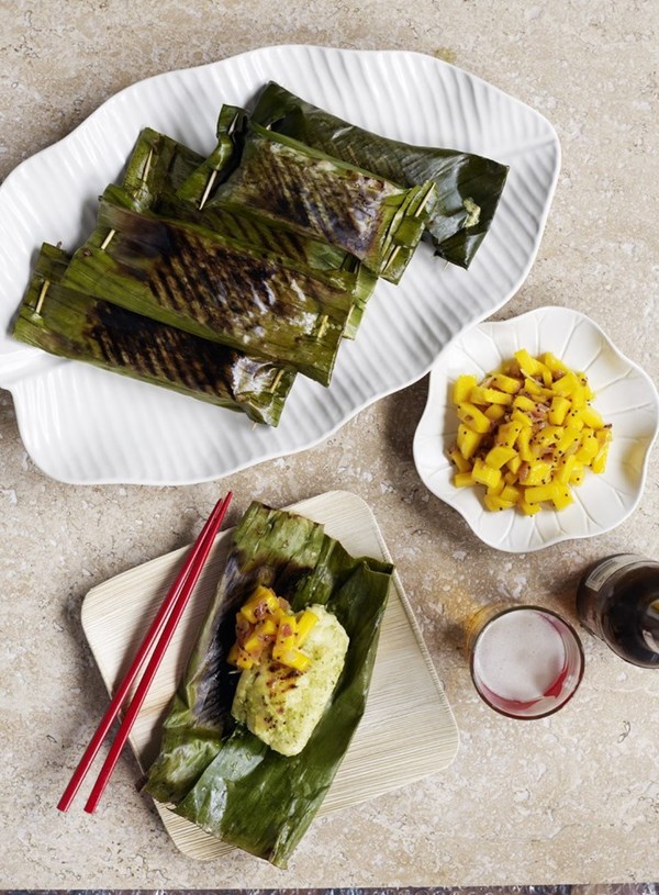 Baked fish in banana leaves with mango salad