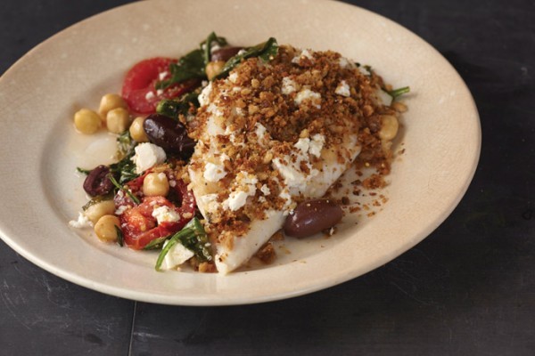 Baked fish on a bed of spinach, chickpeas, and tomatoes