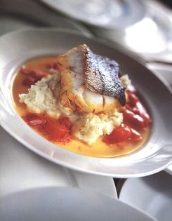 Baked haddock with tomatoes, saffron & wine on mash