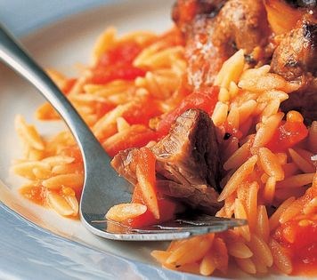 Baked lamb with tomatoes, garlic and pasta