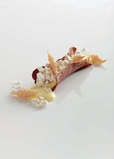 Baked Mountain Man cheese with rye, hazelnut and pickled Chinese artichokes