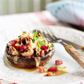 Baked mushrooms with sausage, bacon and tomatoes