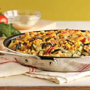 Baked penne with corn, zucchini and basil