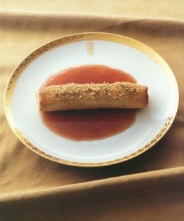 Baked plum and pistachio pastries with spiced plum sauce