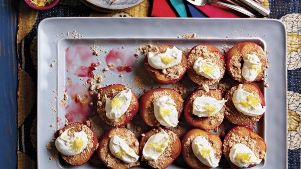 Baked plums with cardamom nut crumble and cream