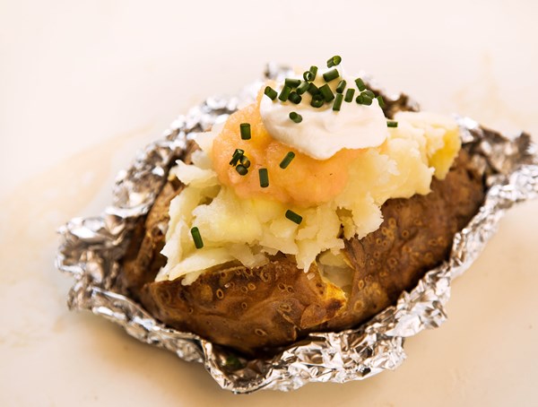 Baked potato stuffed with applesauce, sour cream, and chives