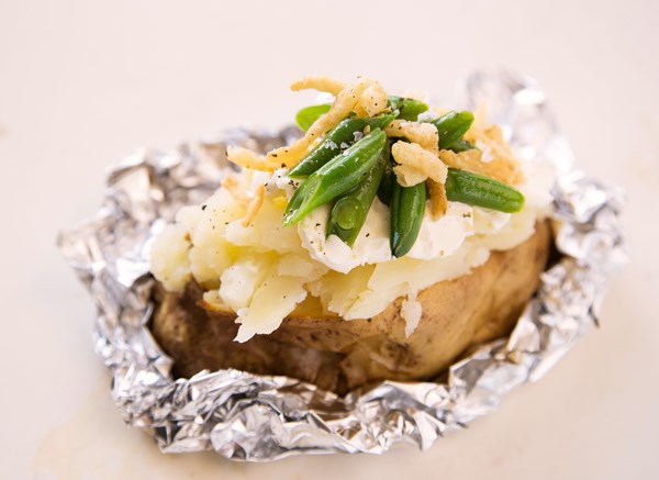 Baked potato stuffed with creamy green beans and crispy onions