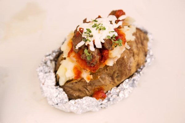 Baked potato stuffed with crumbled sausage, marinara, and mozzarella