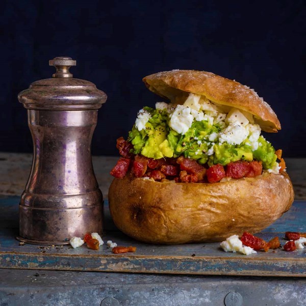 Baked potato with avocado, lime, chilli, feta and smoked bacon