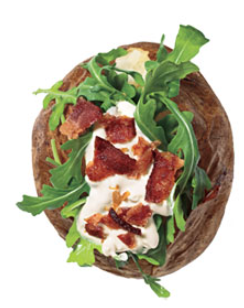Baked potatoes with arugula, sour cream, and bacon