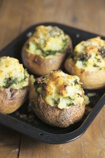 Baked potatoes with cheesy kale filling