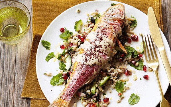 Baked red mullet with tahini dressing, sumac and barley, black olive and pomegranate salad