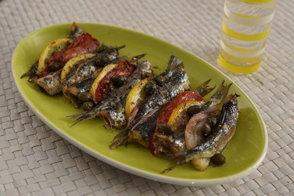 Baked sardines with ouzo, tomatoes, capers, and lemon (Sardeles psites me ouzo, ntomata, kapari kai lemoni)