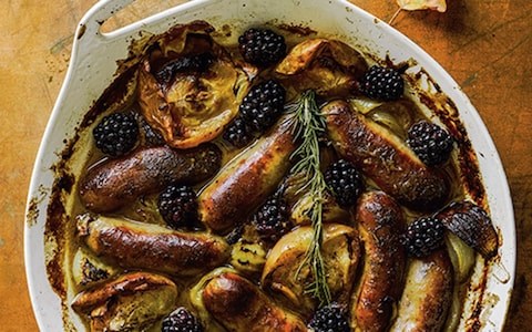 Baked sausages, apples and blackberries with mustard and maple syrup