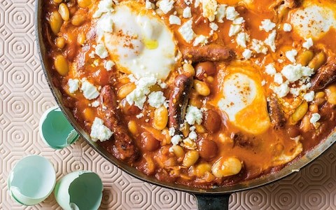 Baked sausages with beans, eggs and feta