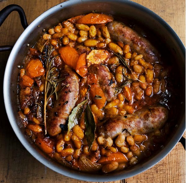 Baked sausages with harissa and tomatoes