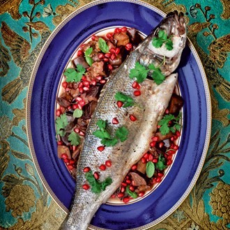 Baked sea bass with aubergine, walnuts & pomegranates