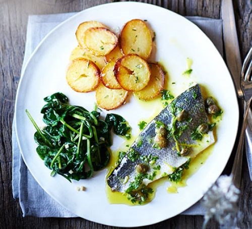 Baked sea bass with lemon caper dressing, rosemary potatoes & garlic spinach