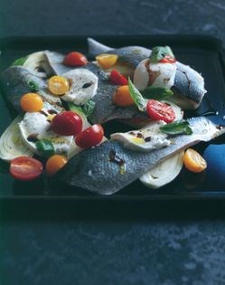 Baked sea bass with mozzarella, olives and tomatoes